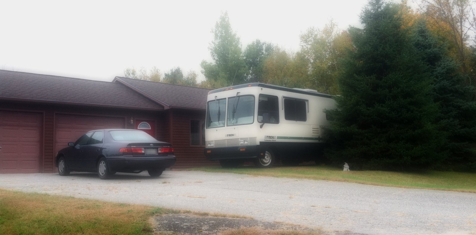 Motorhome Parked in front of a house with a toyota camery