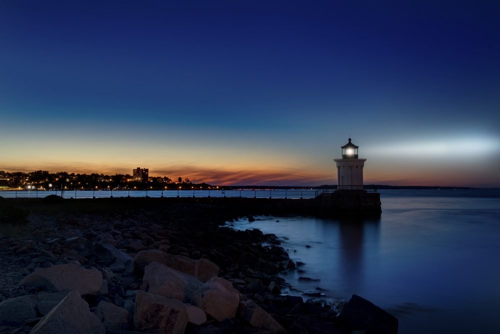 Lighthouse light shining at night off the Maine Coast
