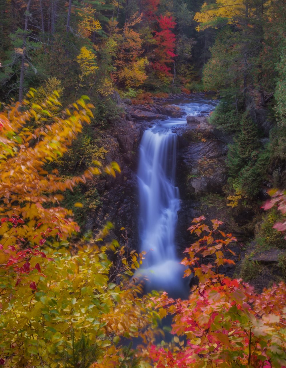 Bright Maine Fall colors frame a 100' waterfall