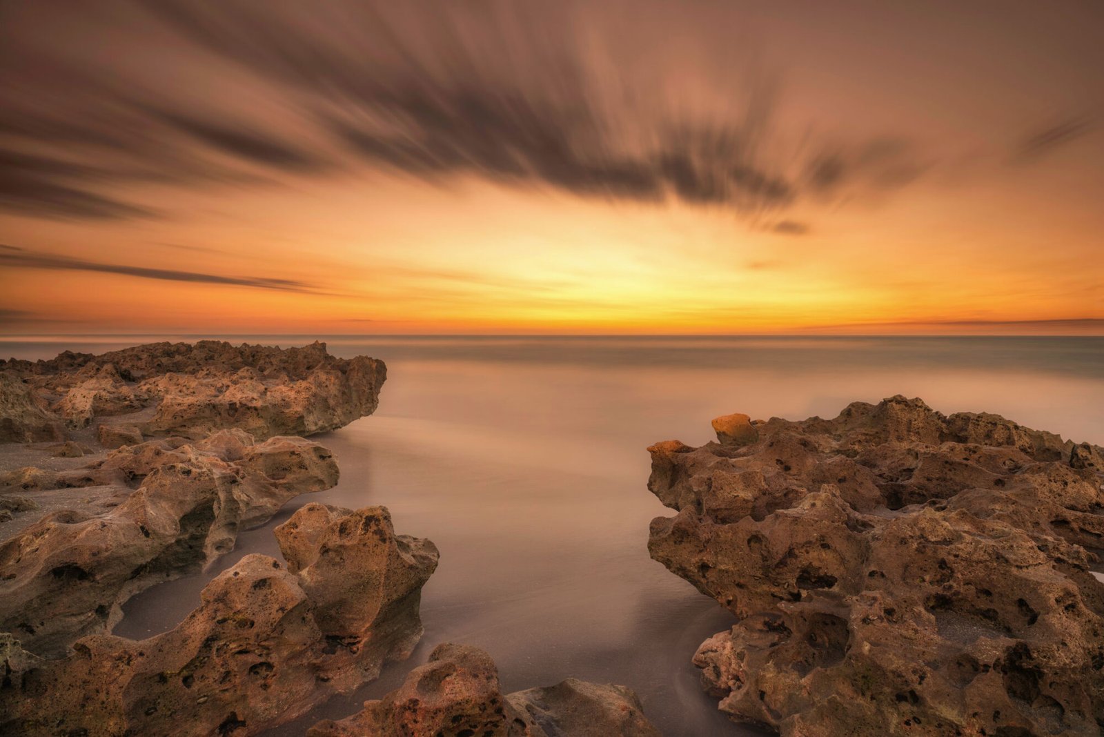 Streaking clouds at sunrise on the coast at Florida's Blowing Rocks Preserve