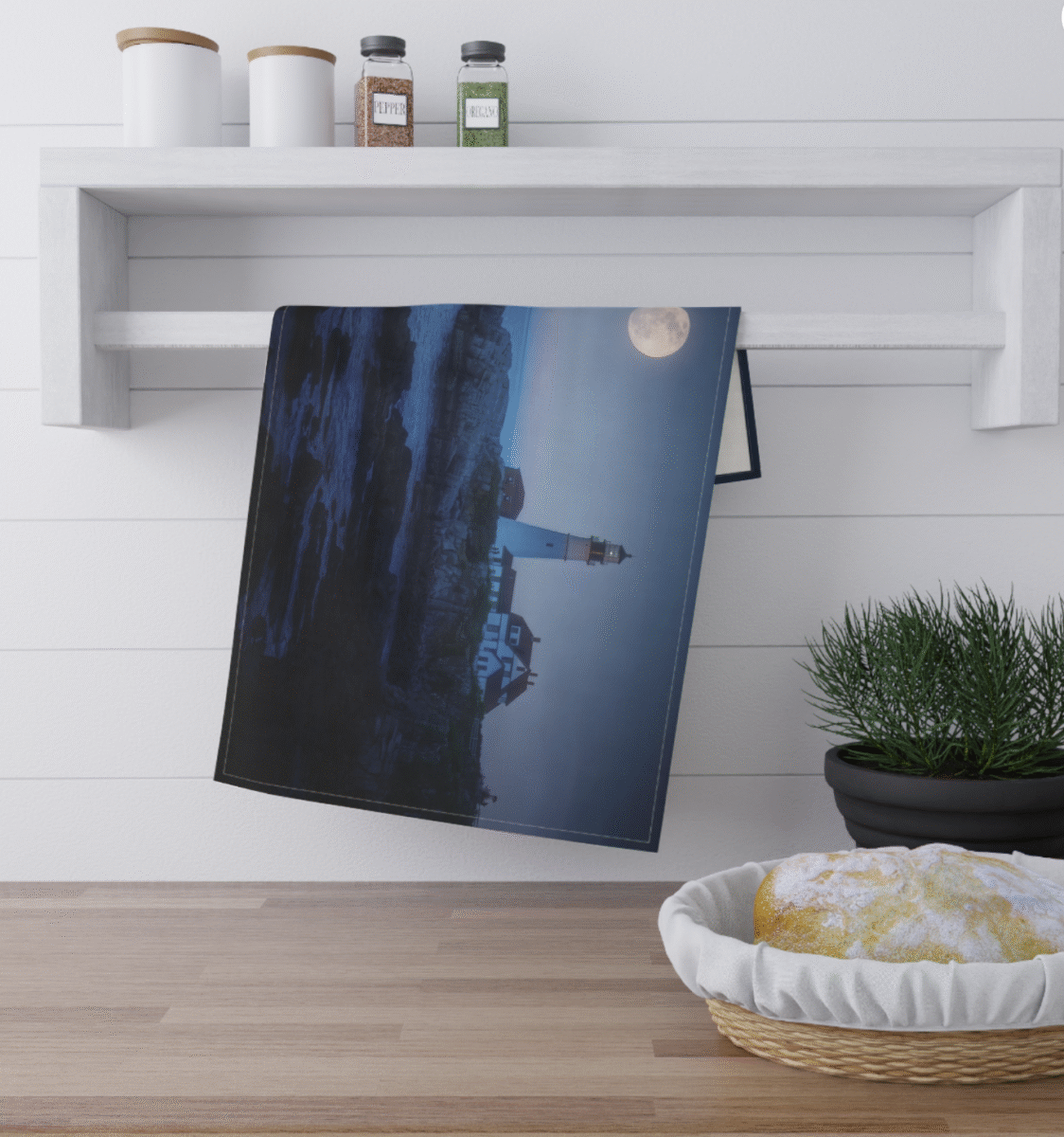 Lighthouse on a rocky coast at night, illuminated by a full moon in a dark blue sky.