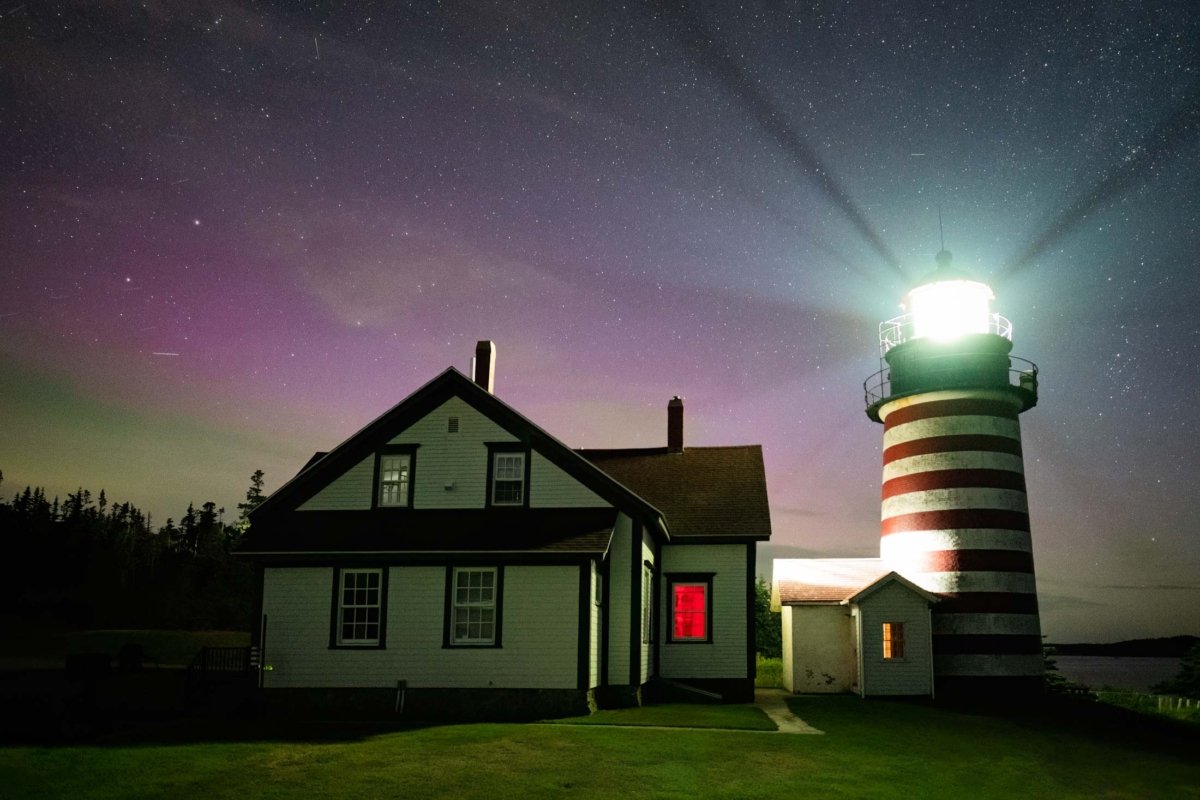 West Quoddy Light in Lubec, Maine, under a starry sky with subtle northern lights visible, photographed in September 2024.