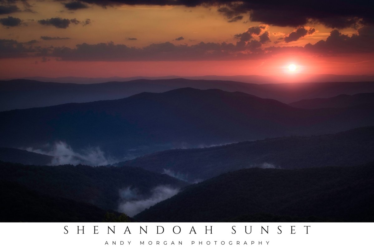 Vibrant sunset over layered blue and purple mountains in Shenandoah National Park, Virginia, with a bright sun on the horizon and clouds above.