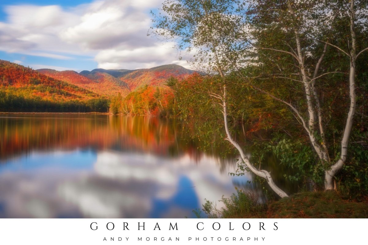 Vibrant poster titled "Gorham Colors" showcasing a landscape with mountains ablaze in autumn foliage reflected in a still lake under a blue and cloudy sky.