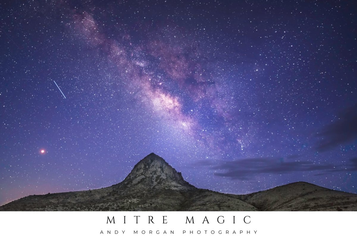 The Milky Way galaxy arcs majestically across a dark night sky, filled with countless stars, above the prominent peak of Mitre Peak near Fort Davis, Texas.