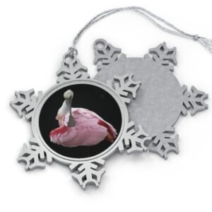A snowflake-shaped pewter ornament featuring a close-up photograph of a roseate spoonbill with its head tucked back, surrounded by a silver frame.