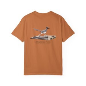 Orange-brown t-shirt featuring a graphic of Paisano Pete, the large roadrunner statue, standing on a white and gray base. Text below the graphic reads "Paisano Pete" and "FORT STOCKTON, TEXAS."
