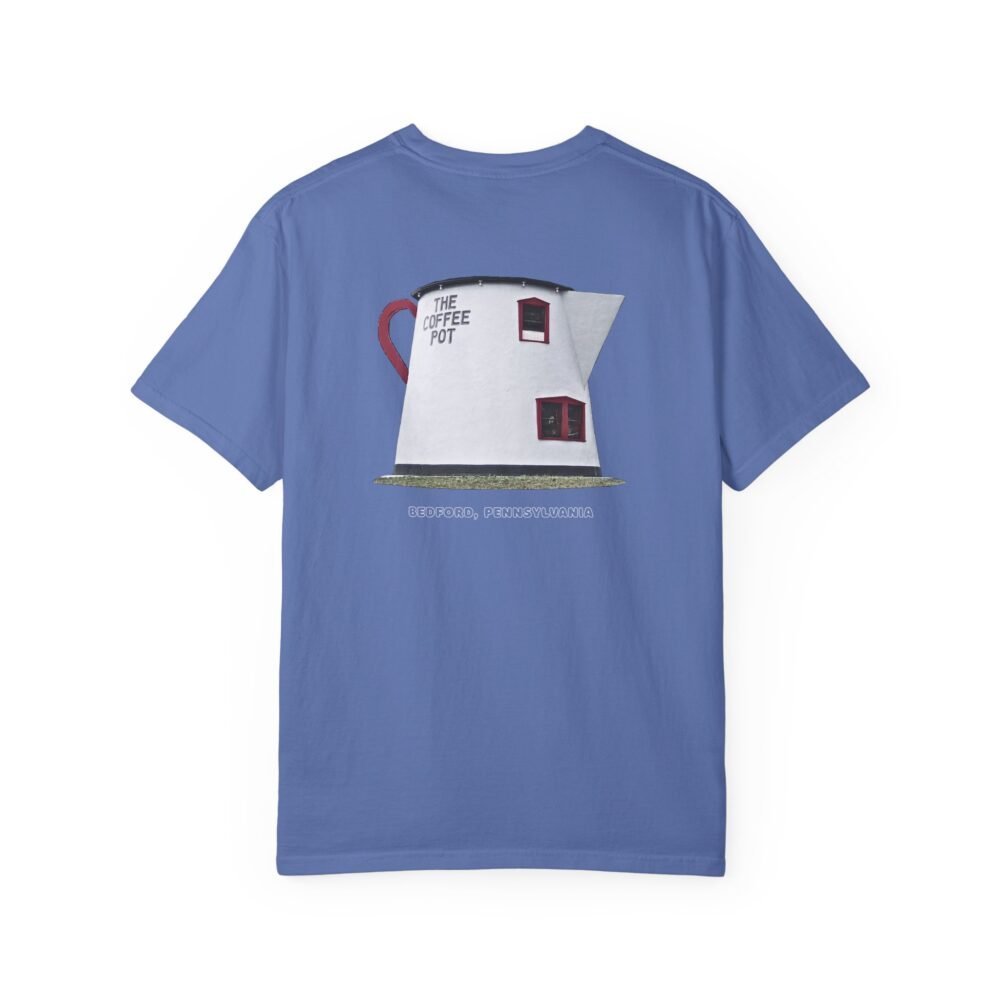 Blue t-shirt featuring a graphic of The Coffee Pot building in Bedford, Pennsylvania, a unique roadside attraction with a red handle and windows. The text "THE COFFEE POT" and "BEDFORD, PENNSYLVANIA" are visible.