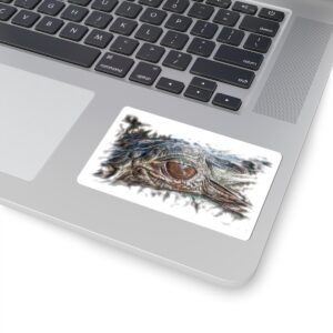 Laptop with a rectangular sticker featuring a close-up of an alligator's eye and snout.