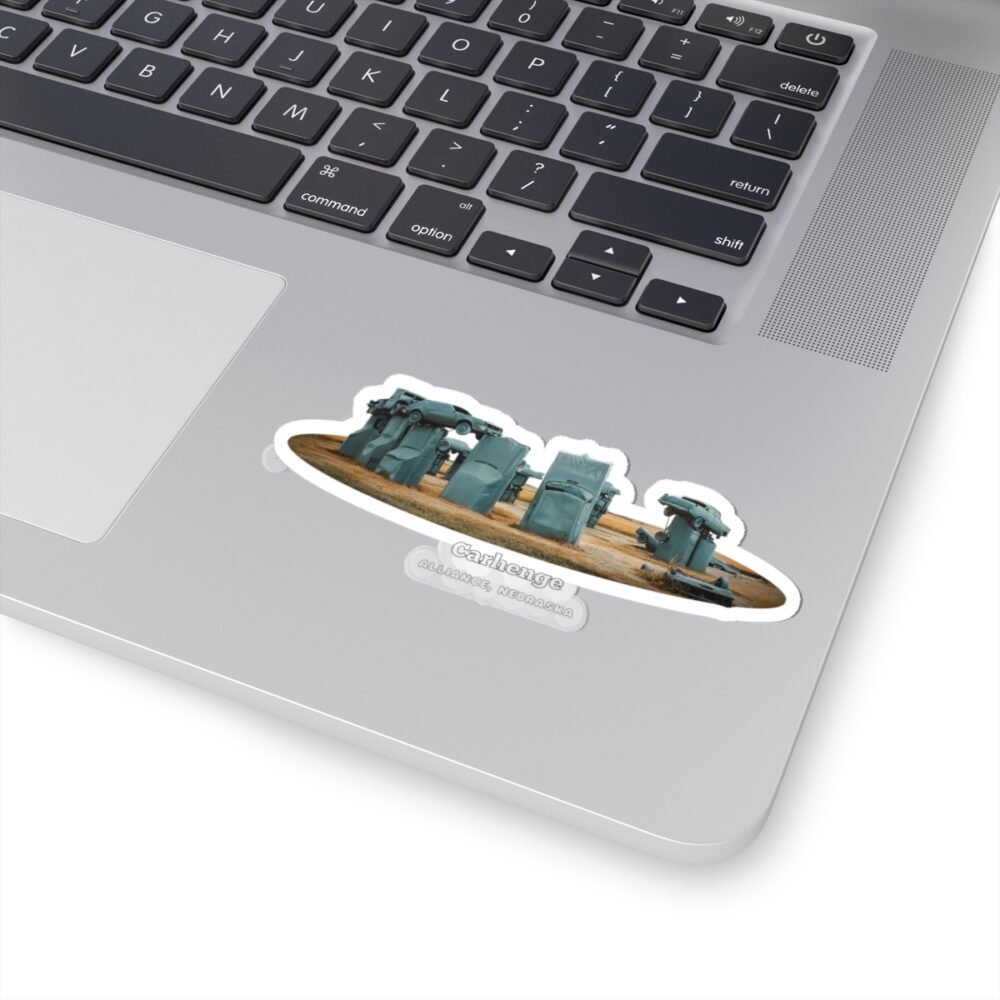 A die-cut sticker featuring a graphic of Carhenge, a replica of Stonehenge made from vintage gray cars, with text reading "CARHENGE ALLIANCE, NEBRASKA."