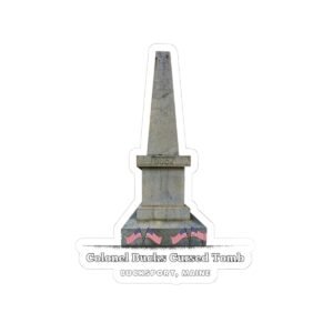 A die-cut sticker featuring a graphic of a tall, grey stone obelisk with a dark stain near the base, and text that reads "Colonel Bucks Cursed Tomb BUCKSPORT, MAINE."