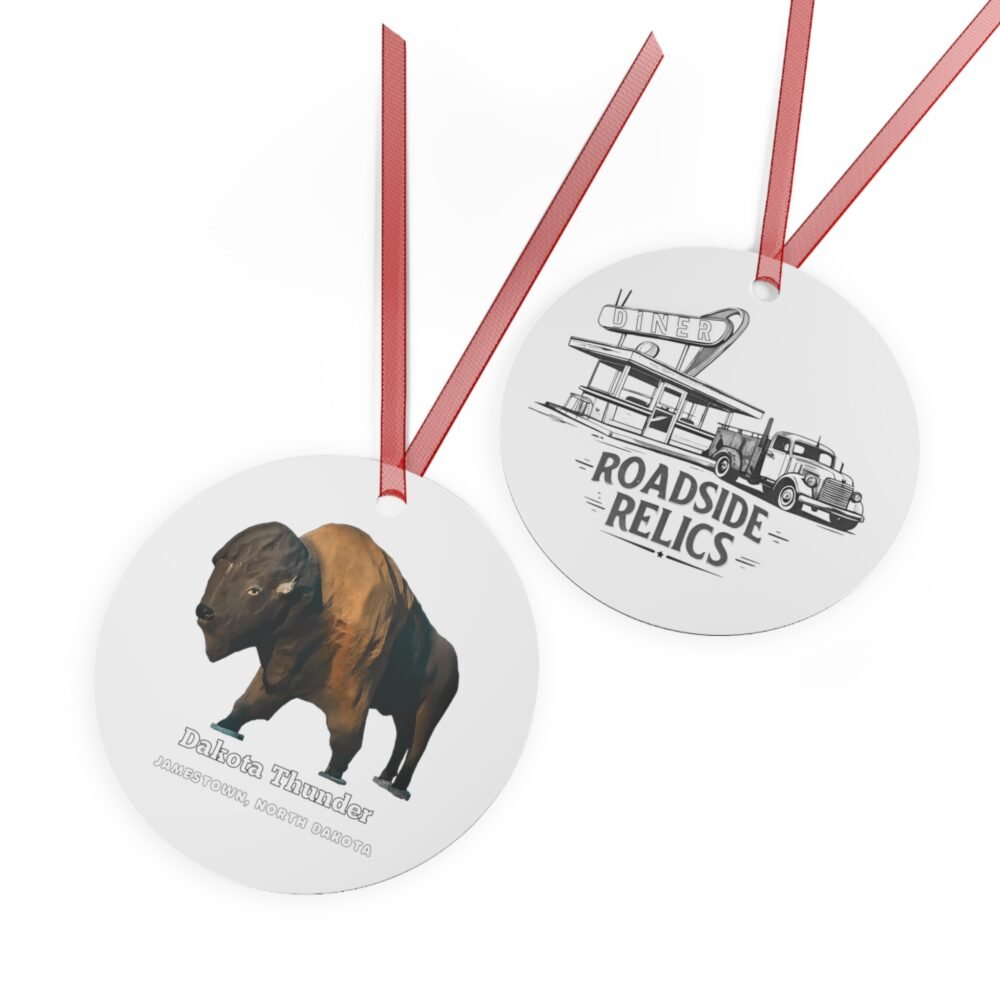 A two-sided oval ornament with a red ribbon, featuring the "Dakota Thunder" bison statue on one side and a "ROAD SIDE RELICS" diner graphic on the other.