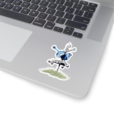 Laptop with a sticker of a blues crossroads sign with a blue guitar and "THE CROSSROADS" text.