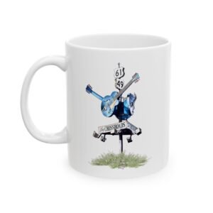 White ceramic coffee mug featuring a blues crossroads sign with a blue guitar and "THE CROSSROADS" text.