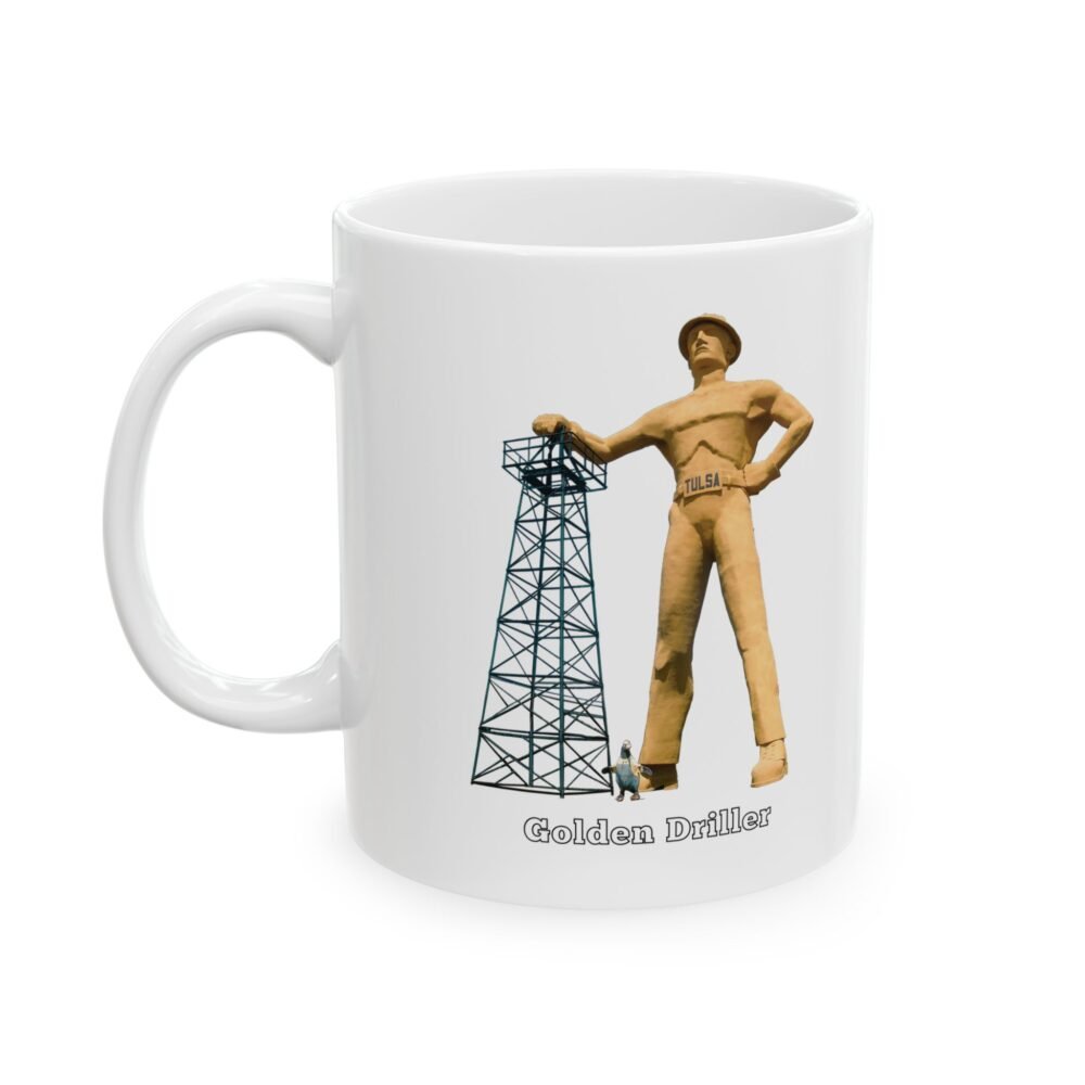 A white ceramic coffee mug with a graphic of the "Golden Driller," a large oil worker statue, standing next to an oil derrick, with text that reads "Golden Driller TULSA, OKLAHOMA."