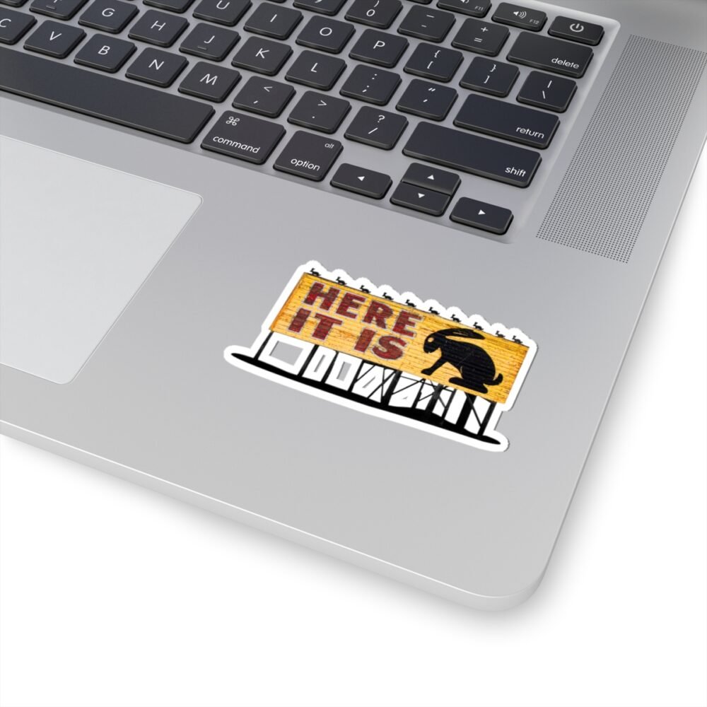 Laptop with a die-cut sticker of the "HERE IT IS" jackalope sign from Joseph City, Arizona.