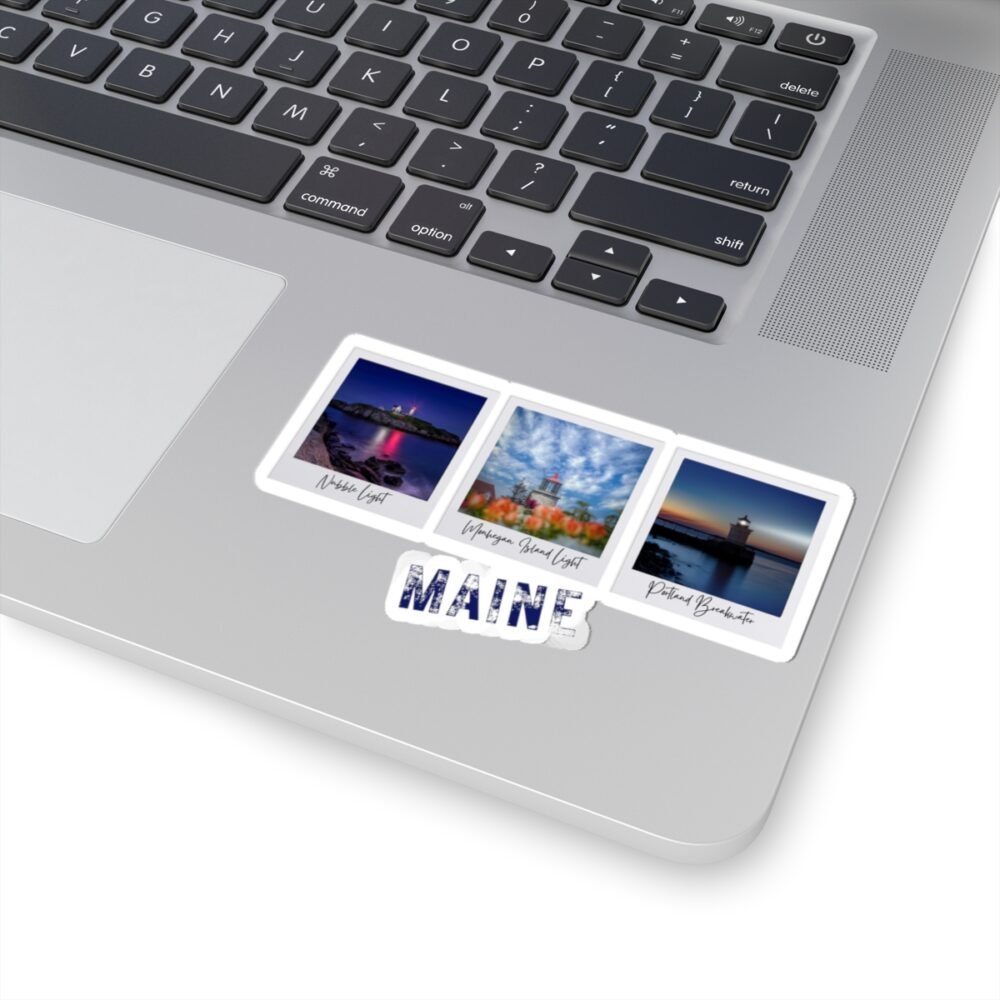 Laptop with a rectangular sticker featuring three Maine lighthouses and "MAINE" text.