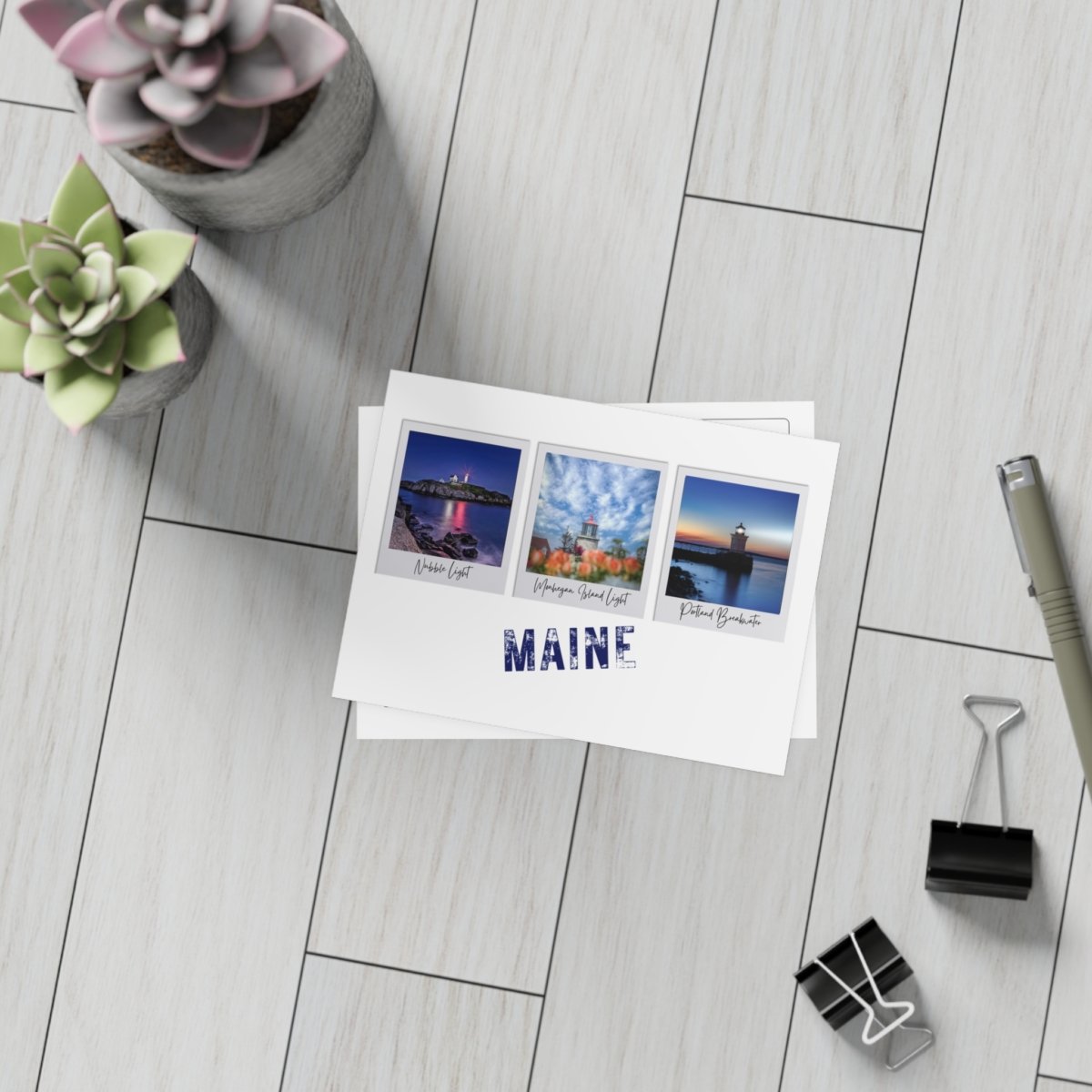 Stack of postcards with three Maine lighthouses and "MAINE" text at the bottom.
