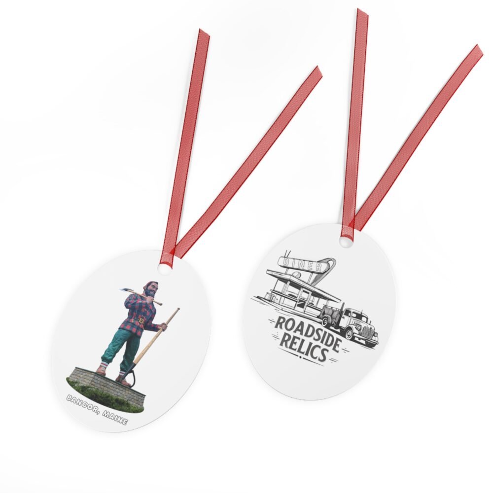 A two-sided oval ornament with a red ribbon, featuring the Paul Bunyan statue from Bangor, Maine on one side and a "ROAD SIDE RELICS" diner graphic on the other.