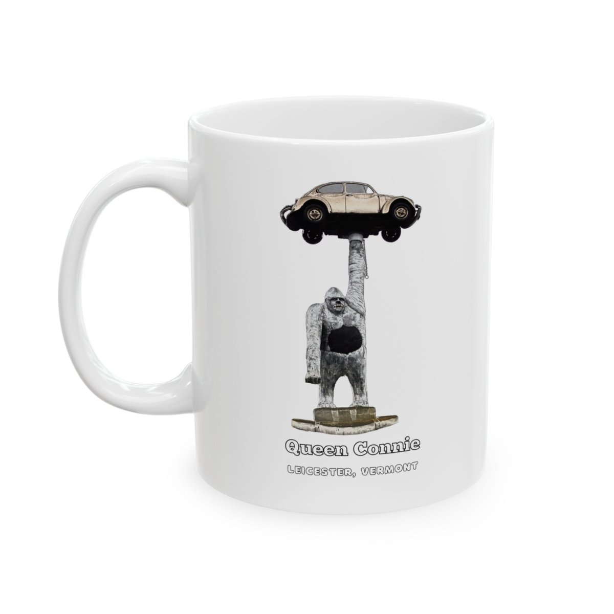 White ceramic coffee mug featuring Queen Connie, a gorilla statue holding a Volkswagen Beetle, with "LEICESTER, VERMONT" text.