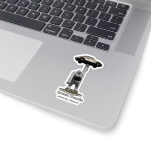 Laptop with a sticker of Queen Connie, a gorilla statue holding a Volkswagen Beetle.