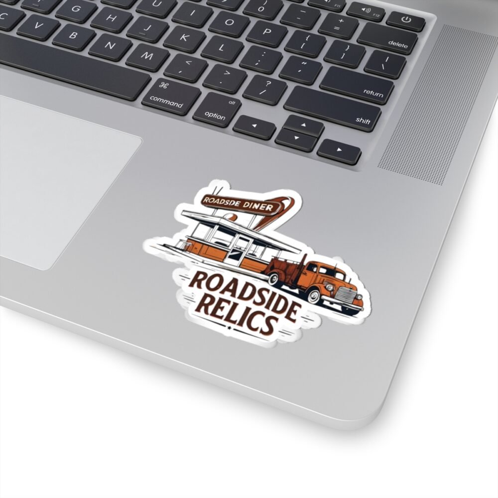 Laptop with a die-cut sticker featuring a retro diner and vintage truck with "ROADSIDE RELICS" text.