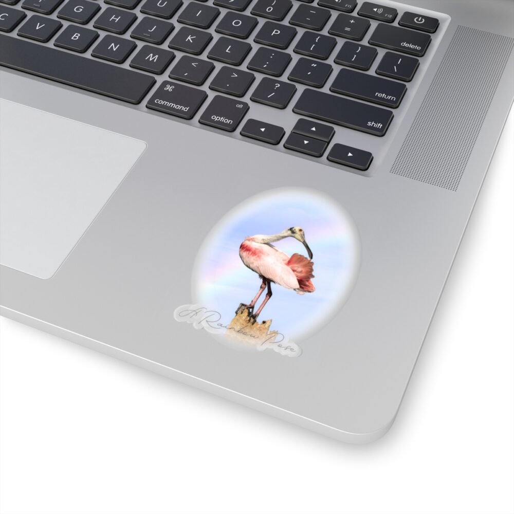 Laptop with an oval sticker of a pink Roseate Spoonbill bird on a wooden post.