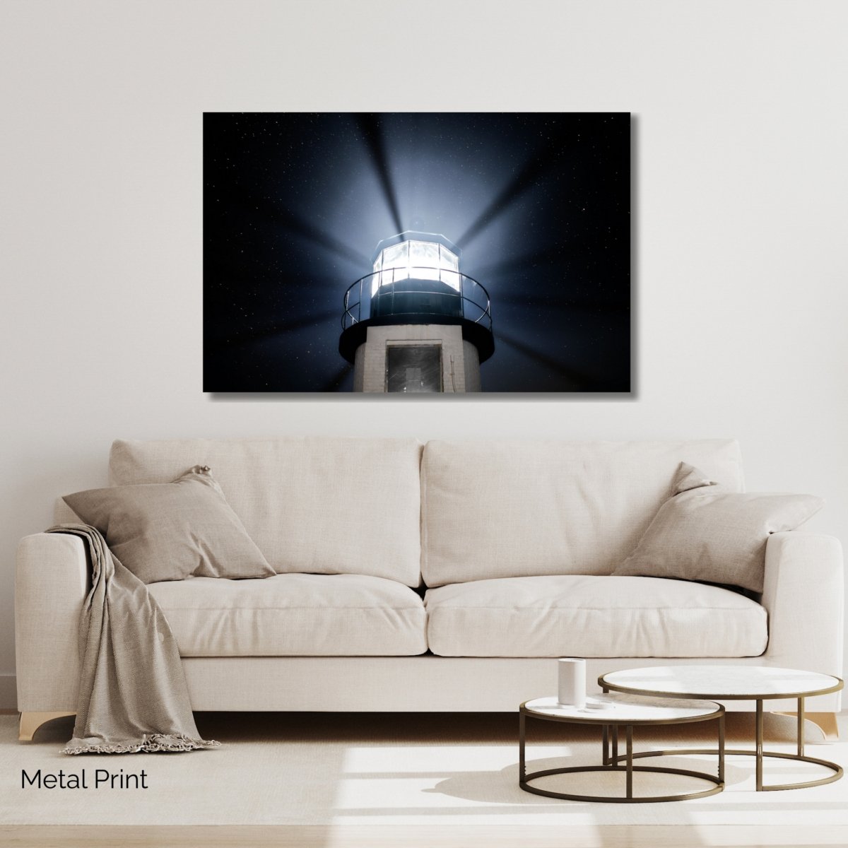 A close-up photograph looking up at the top of the Marshall Point Lighthouse in Port Clyde, Maine, with its powerful light beams fanning out against a clear, starry night sky.